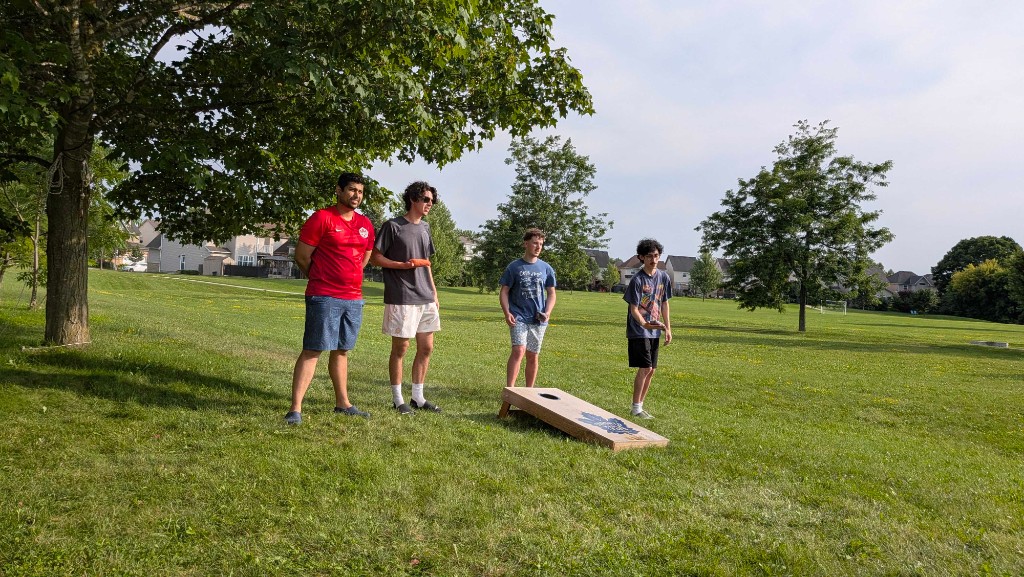 Sera4 teammates playing cornhole at the offsite